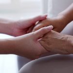 Close up hand of young asia woman or nurse home care holding senior